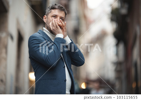 An adult man plays the harmonica on the street An adult man plays the harmonica on the street 103115655