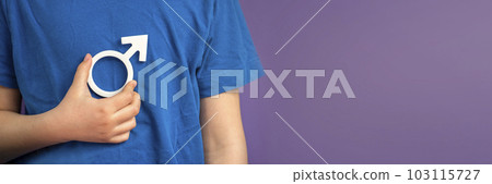 Gender symbol of a man. Symbol of a man in his hands on a purple background with copy space. The concept of male leadership or gender equality. 103115727