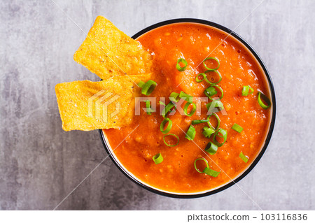 Close up of traditional mexican salsa sauce and corn chips in a bowl top view Close up of traditional mexican salsa sauce and corn chips in a bowl top view 103116836