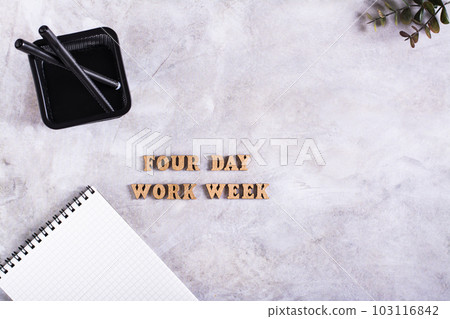Four day work week concept with wooden letters on desk top view 103116842