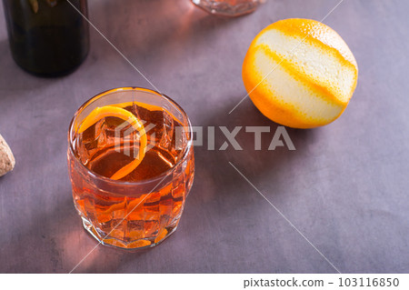 Cold cocktail Negroni Sbagliato with liqueur, vermouth and orange in glasses on the table Cold cocktail Negroni Sbagliato with liqueur, vermouth and orange in glasses on the table 103116850