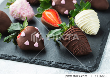 Gourmet chocolate covered strawberries on the light background 103116889