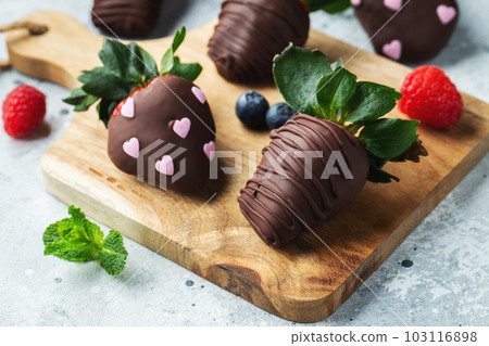 Gourmet chocolate covered strawberries on the light background Gourmet chocolate covered strawberries on the light background 103116898