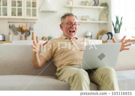 Excited middle aged senior man euphoric winner. Older mature grandfather looking at laptop reading great news getting good result winning online bid feeling amazed. Winning gesture Excited middle aged senior man euphoric winner. Older mature grandfather looking at laptop reading great news getting good result winning online bid feeling amazed. Winning gesture 103116933