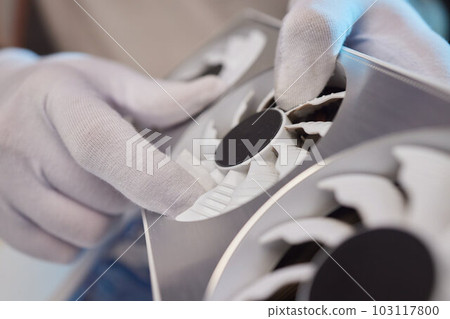 Changing the thermal paste on the graphics processor. Disassembled graphics card on the table. Old graphics card service. 103117800