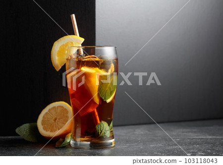 Iced tea or a summer refreshing drink with ice, mint, and lemon. Iced tea or a summer refreshing drink with ice, mint, and lemon. 103118043