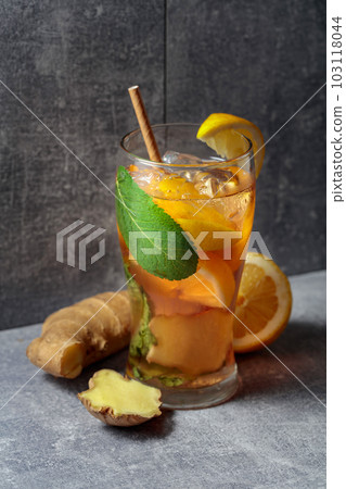 Iced tea with mint, ginger, and lemon on a grey background. 103118044