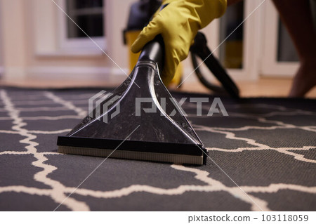 Close-up Of A Person Cleaning Carpet With Vacuum Cleaner. Close-up Of A Person Cleaning Carpet With Vacuum Cleaner. 103118059