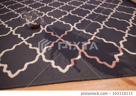 glass of red wine fell on carpet, drink spilled on floor. 103118115