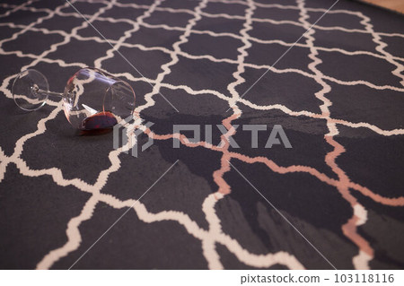 glass of red wine fell on carpet, drink spilled on floor. glass of red wine fell on carpet, drink spilled on floor. 103118116