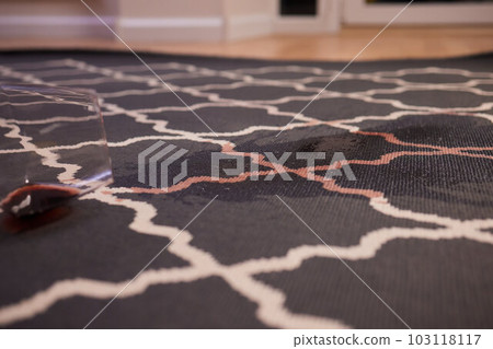 glass of red wine fell on carpet, drink spilled on floor. glass of red wine fell on carpet, drink spilled on floor. 103118117