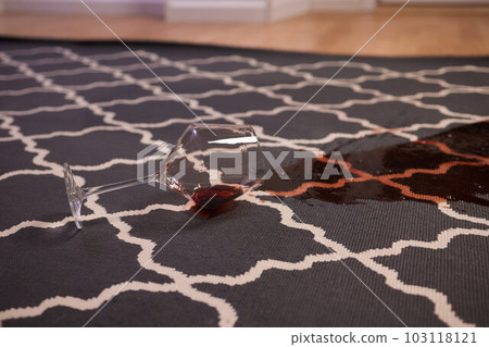 glass of red wine fell on carpet, drink spilled on floor. 103118121