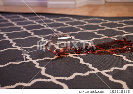glass of red wine fell on carpet, drink spilled on floor. glass of red wine fell on carpet, drink spilled on floor. 103118128