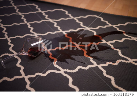 glass of red wine fell on carpet, drink spilled on floor. 103118179