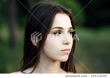 Mindfulness Practices to Connect with Nature, relaxation breathing techniques. Outdoor portrait of calm young woman in nature background Mindfulness Practices to Connect with Nature, relaxation breathing techniques. Outdoor portrait of calm young woman in nature background 103118397