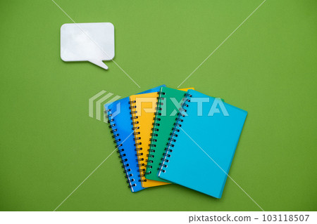 Collection different bright school stationery and notebooks on green background, flat lay. Back to school concept 103118507