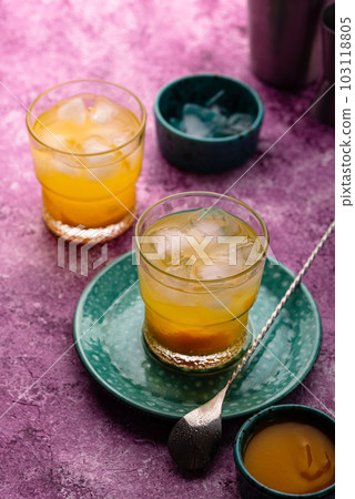 Summer cocktail with mango juice and ice 103118805