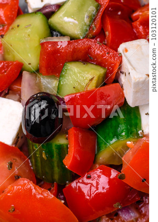 Delicious fresh juicy greek salad with feta cheese, olives, peppers and tomatoes 103120101