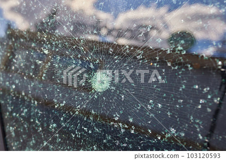 Smashed windscreen of a car, damaged glass. Smashed windscreen of a car, damaged glass. 103120593