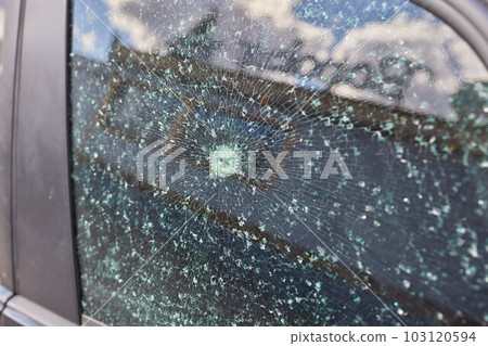 Smashed windscreen of a car, damaged glass. Smashed windscreen of a car, damaged glass. 103120594