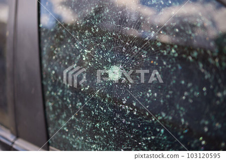 Smashed windscreen of a car, damaged glass. Smashed windscreen of a car, damaged glass. 103120595