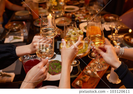 Clinking glasses with alcohol and toasting, party. 103120611