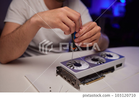 Changing the thermal paste on the graphics processor. Disassembled graphics card on the table. Old graphics card service. 103120710