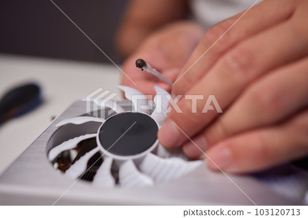 Changing the thermal paste on the graphics processor. Disassembled graphics card on the table. Old graphics card service. 103120713