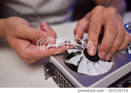 Changing the thermal paste on the graphics processor. Disassembled graphics card on the table. Old graphics card service. 103120714