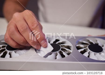 Changing the thermal paste on the graphics processor. Disassembled graphics card on the table. Old graphics card service. 103120718