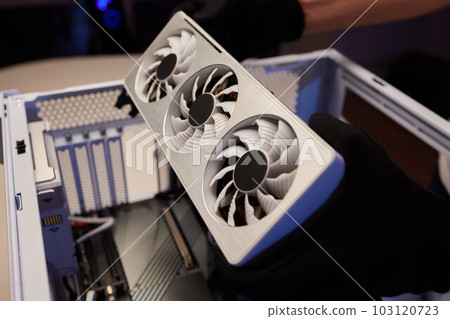 Changing the thermal paste on the graphics processor. Disassembled graphics card on the table. Old graphics card service. 103120723