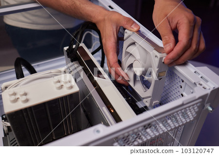 Computer technician installs cooling system of computer. 103120747