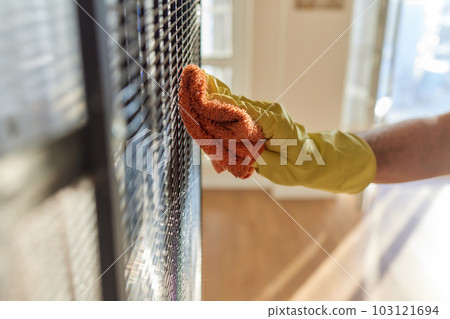 Cleaning with a brush from contaminations of the ribbed tube condenser of a household refrigerator. 103121694
