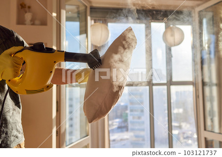 man steaming pillow at home, closeup view. man steaming pillow at home, closeup view. 103121737