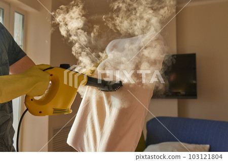 man steaming pillow at home, closeup view. man steaming pillow at home, closeup view. 103121804
