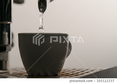 Rinsing with single spout portafilter from coffee machine closeup Rinsing with single spout portafilter from coffee machine closeup 103122237