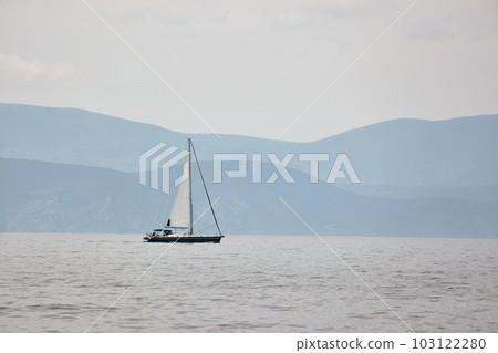 Sailing boat in the distance Sailing boat in the distance 103122280