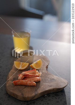 Delicious peeled crab legs with lemon and ginger beer Delicious peeled crab legs with lemon and ginger beer 103122910
