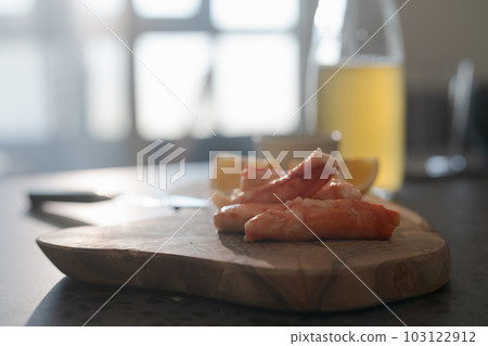 Crab legs with lemon and dressing on olive woob board Crab legs with lemon and dressing on olive woob board 103122912