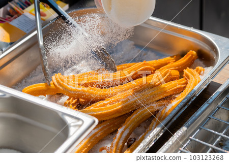 Chef preparing homemade crunchy churros at street food market: close up Chef preparing homemade crunchy churros at street food market: close up 103123268