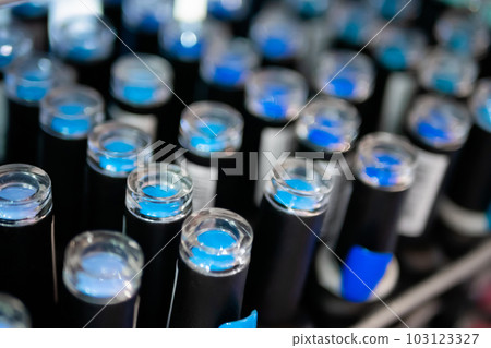 Set of blue nail varnishes on counter of cosmetic shop 103123327