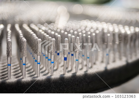 Collection of dental tungsten burs, dental equipment, tools in row Collection of dental tungsten burs, dental equipment, tools in row 103123363