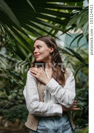 Portrait of young woman in botanical garden. Portrait of young woman in botanical garden. 103124421