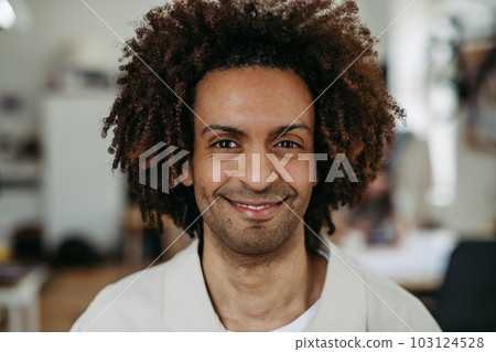 Portrait of young multiracial man in office. Portrait of young multiracial man in office. 103124528