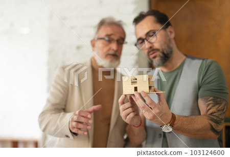 Young architects designing house for seniors client. Young architects designing house for seniors client. 103124600