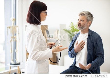 Patient talking about chest pain with medical specialist Patient talking about chest pain with medical specialist 103124925