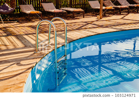 A handrail for pool stairs is an important safety feature in a swimming pool. A handrail for pool stairs is an important safety feature in a swimming pool. 103124971