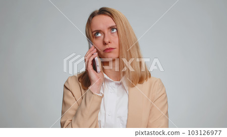 Tired sleepy disinterested business woman having annoyed boring talk on smartphone, conversation Tired sleepy disinterested business woman having annoyed boring talk on smartphone, conversation 103126977