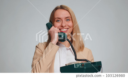 Business woman talking on wired vintage telephone of 80s says hey you call me back operator helpline Business woman talking on wired vintage telephone of 80s says hey you call me back operator helpline 103126980