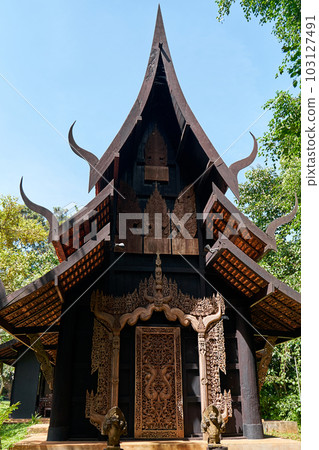 intricate details of the buildings' design and the contrast between their sharp edges and organic surroundings. 103127491